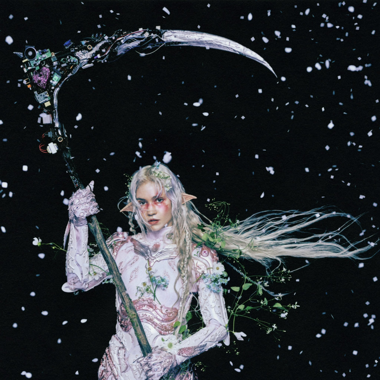 Eve holding a scythe made of circuit boards under falling petals